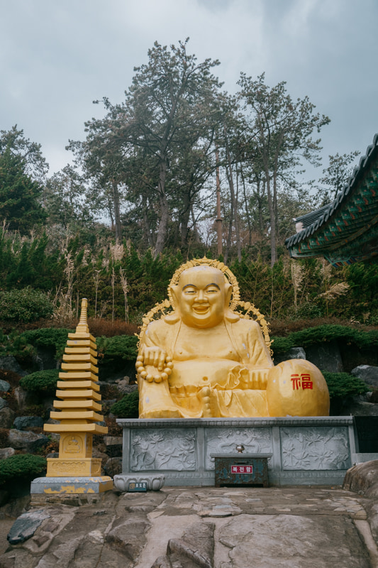 Statue dorée de Bouddha assis à Haedong Yonggungsa